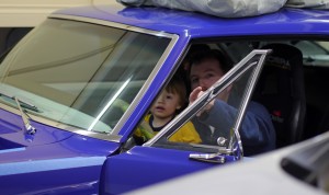 Griffin helps his dad get the Camaro idling right